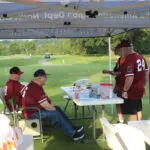 Four Men in a Golf Course by the STand