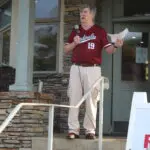 A Man in a Red Color Shirt Standing on the Stairs