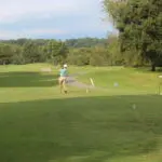 A Man in a Light Blue Top Playing Golf