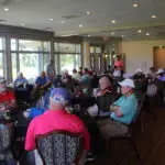 A Group of Men Sitting by Tables Inside a Restaurant