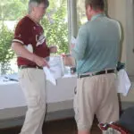 Two Men Talking by a Refreshments Table