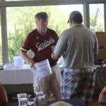 Two Men Talking by a Refreshments Table