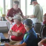 A Group of Men Sitting in a Restaurant Copy