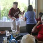 A Man in a Maroon Color Baseball Top