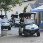 A Golf Cart With People Inside a Cart