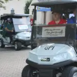 A Set of Two Golf Carts Driving Towards the Course