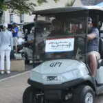 Two Men Driving in a Golf Cart Towards the Ground