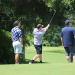 A Man Striking a Shot on the Golf Course