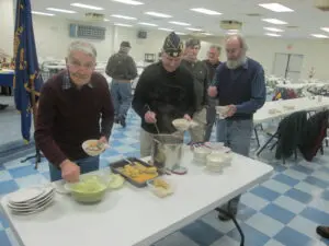 A Group of People Standing by a STand