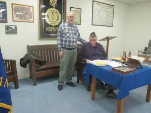 Two Veterans Sitting by a Table With Blue Color