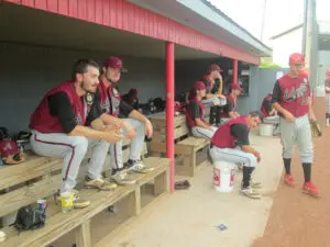 A Group of Baseball Players Sitting on a Wooden Bench