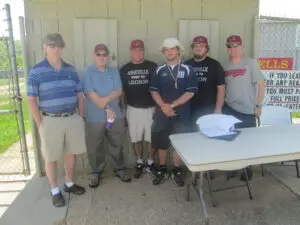 A Group of Men Standing in Front of a Couple of Doors