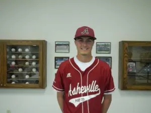 Tyler Anders smiling in his uniform and wearing a cap