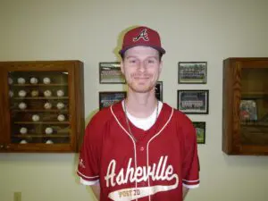 Asst Coach Michael Pegg smiling and wearing a cap