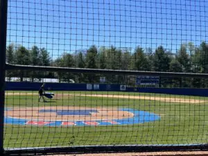 A baseball field with a person maintains it